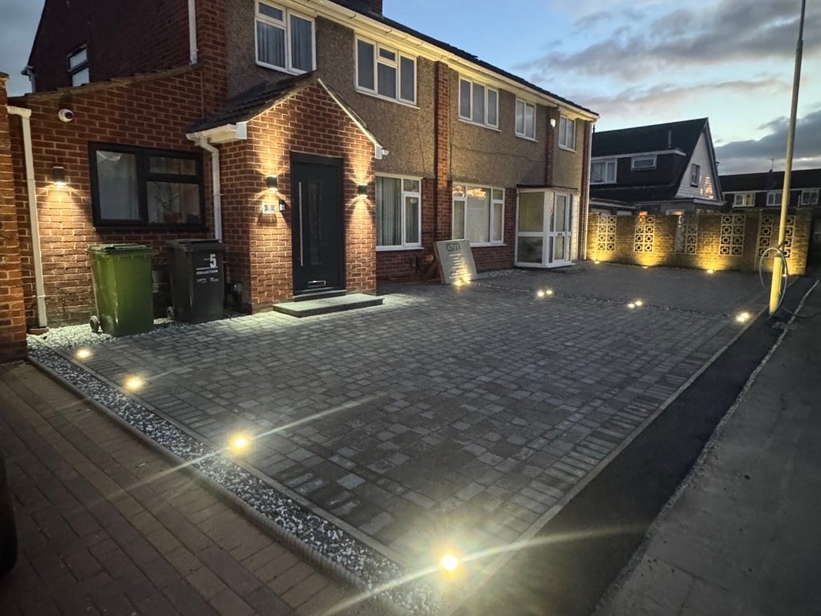 Completed driveway and entrance photographed after dark