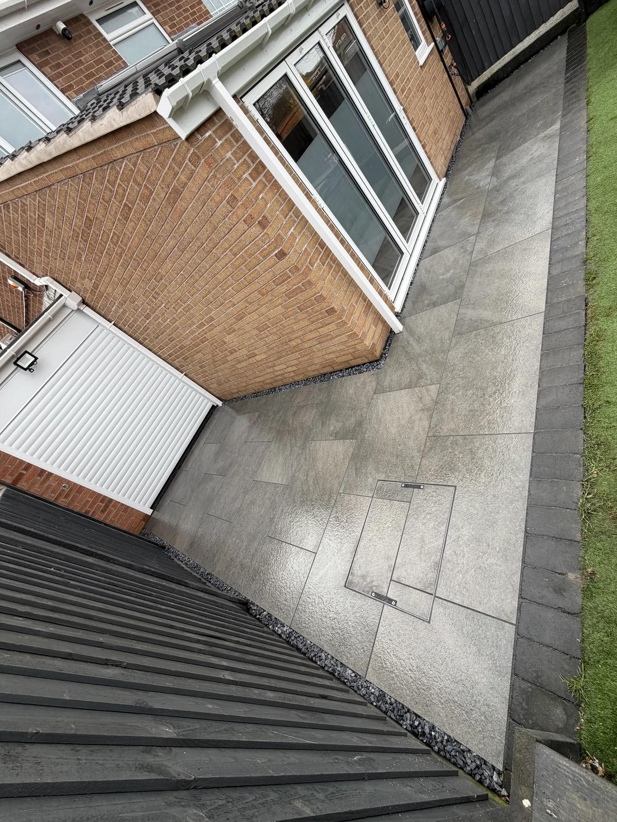 From old decking to a clean grey paved finish